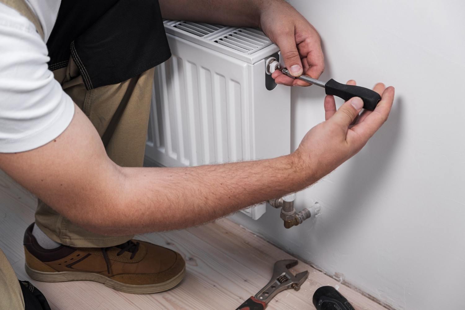 Engineer diagnosing a central heating boiler fault