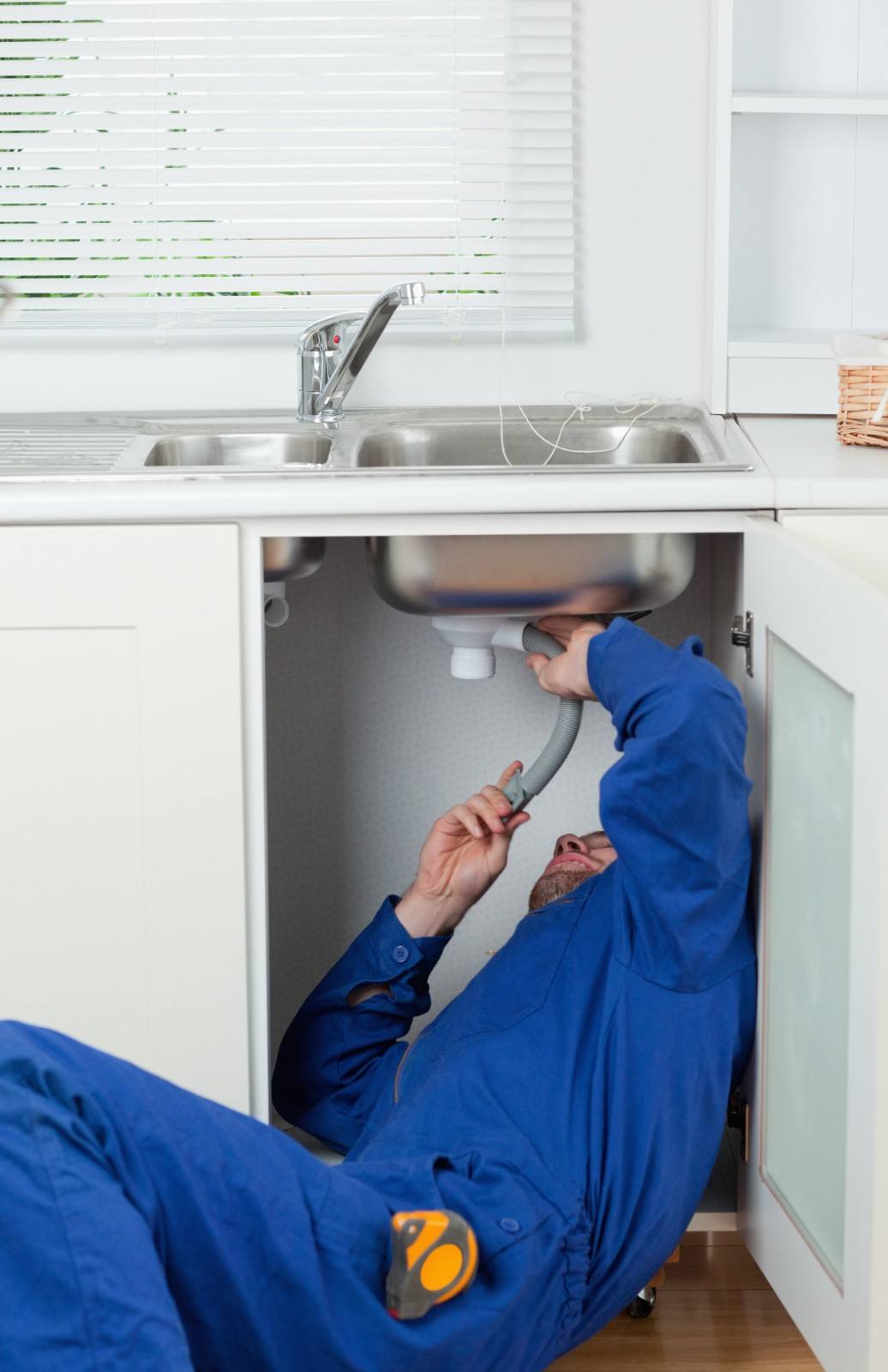Plumber fixing a common plumbing problem in Barnet